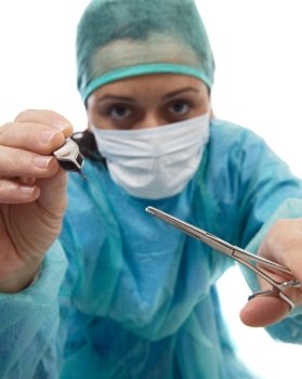 a photo of a woman doctor operating (focus in the tools)