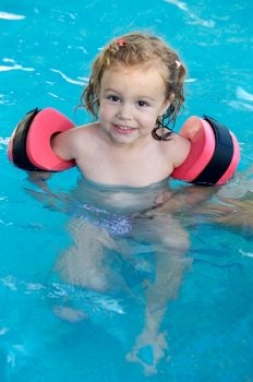 Little girl playing in the swimming pool