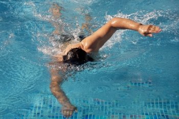photo of a swimmer doing spring in summer