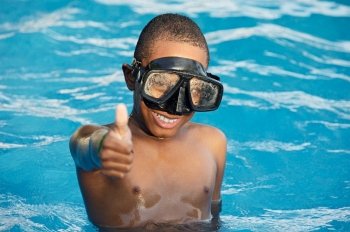 Black boy with glasses in the swimming pool
