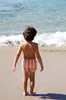 adorable boy playing in the beach over a white background