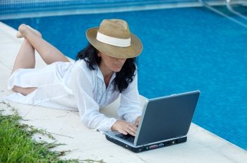 woman working comfortably on the swimming pool