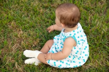 adorable happy baby on the green grass
