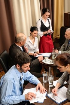 Business people having a company meeting at restaurant waitress ordering