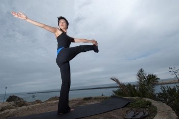 Asian Woman Practicing Yoga at Waterfront