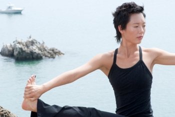 Asian Woman Practicing Yoga at Waterfront