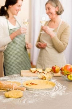 Apple pie baking two women drink wine together in kitchen