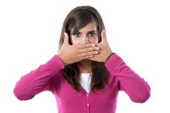 Girl dressed in pink covering her mouth on a white background