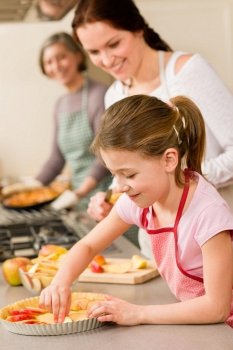Young girl prepare apple tart baking with mother and grandmother