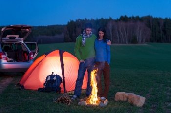 Tent camping car couple romantic stand by bonfire night countryside