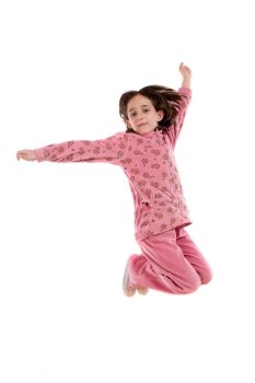 Joyful little girl jumping on a over white background