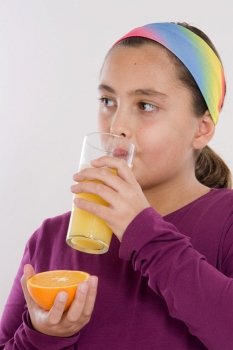 Cute girl drinking a juice of orange