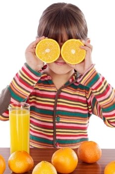 Cute child playing with oranges and juice