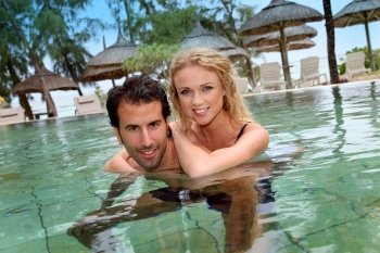 Couple in luxury hotel swimming-pool