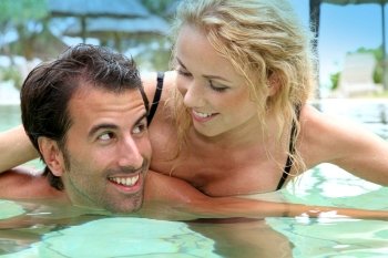 Couple in luxury hotel swimming-pool