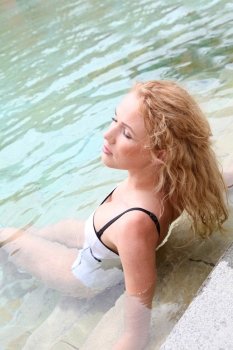 Beautiful woman relaxing in swimming pool