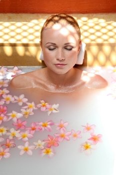 Portrait of beautiful woman in milk bath