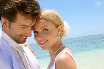 Portrait of just married couple on the beach