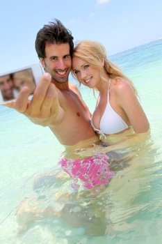 Couple taking picture of themselves in the sea