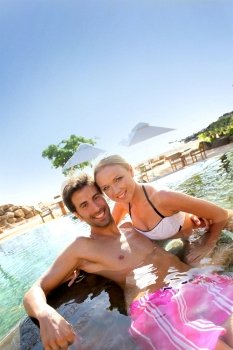 Couple relaxing in luxury hotel swimming-pool