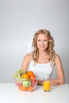 Beautiful blond woman drinking fruit juice