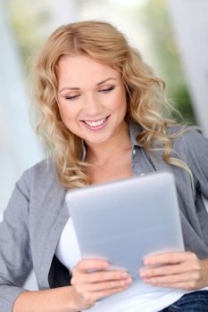 Beautiful woman at home websurfing with digital tablet