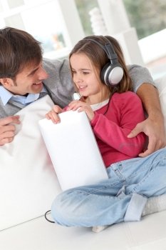 Father and daughter listening to music
