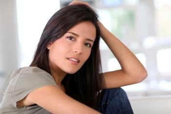 Portrait of attractive young woman relaxing at home