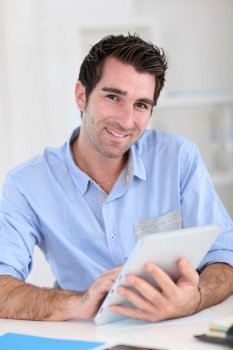 Office worker using electronic tablet