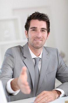 Businessman giving hand towards client
