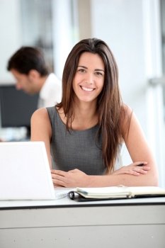 Attractive businesswoman working on laptop computer
