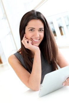 Portrait of smiling student using electronic tablet
