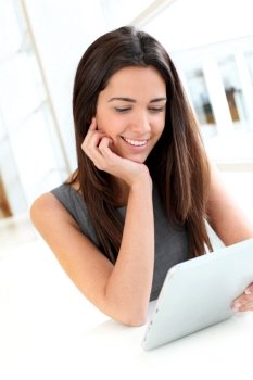 Portrait of smiling student using electronic tablet