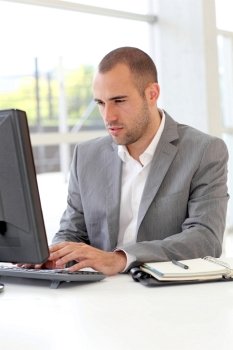 Salesman working on desktop computer