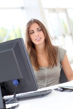 Young woman working on desktop computer