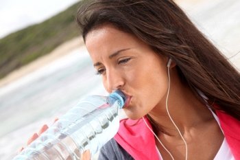 Portrait of jogger drinking water from bottle