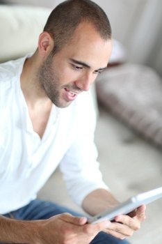 Closeup of handsome man websurfing on touchpad