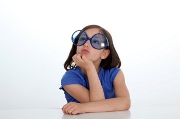 Portrait of little girl with funny sunglasses on