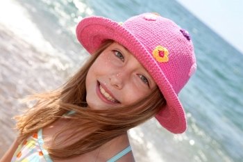 Portrait of young girl wearing hat at the beach