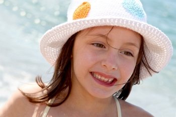 Portrait of young girl wearing hat at the beach