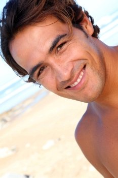 Portrait of handsome guy at the beach
