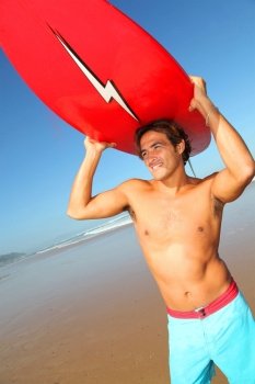 Portrait of handsome surfer at the beach