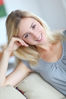 Beautiful smiling woman relaxing in sofa