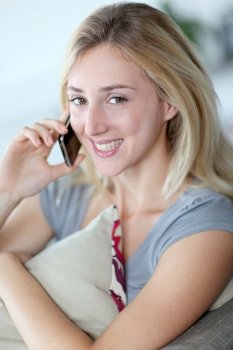 Beautiful woman talking on mobilephone at home