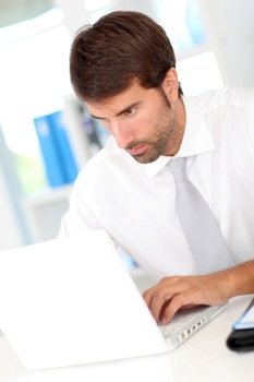 Businessman in office working with laptop computer