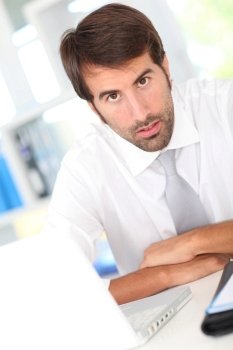 Businessman in office working with laptop computer