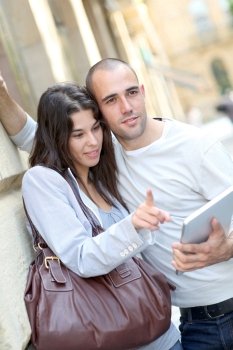 Young couple in town with electronic tablet
