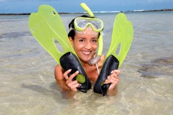 Closeup of smiling woman with diving mask and flippers