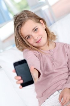Portrait of little girl with mobile phone
