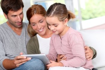 Family using electronic tablet at home